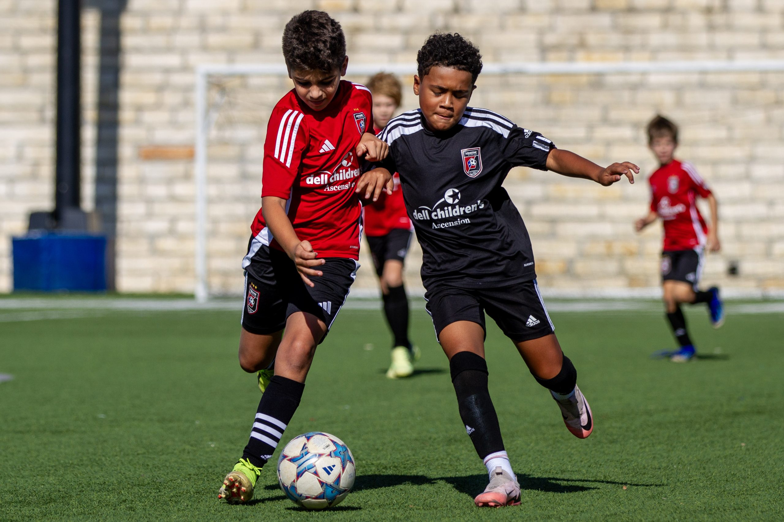 Children playing soccer through the Fini Kids wellness program